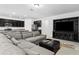 Open-concept living room and kitchen area featuring a gray sectional, dark cabinets, and granite countertops at 806 Armenia Ct, New Smyrna Beach, FL 32168