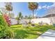 Inviting backyard featuring a cozy fire pit area with rocking chairs and lush green grass at 906 Timberwood Dr, Port Orange, FL 32127