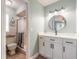 Bathroom featuring a modern vanity with a round mirror and a tiled shower at 906 Timberwood Dr, Port Orange, FL 32127