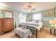 Bright bedroom featuring soothing colors, a ceiling fan, and warm wood flooring at 906 Timberwood Dr, Port Orange, FL 32127