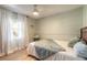 Bright bedroom with a comfortable bed, natural light, and a ceiling fan at 906 Timberwood Dr, Port Orange, FL 32127