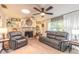 Inviting living room with stone fireplace, built-in shelving, and large windows with natural lighting at 906 Timberwood Dr, Port Orange, FL 32127