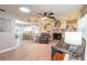 Cozy living room with wood flooring, a stone fireplace, and ample natural light at 906 Timberwood Dr, Port Orange, FL 32127