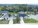 Aerial view showcases the neighborhood with lush green trees and manicured lawns at 113 Plumosus Park Dr, Deland, FL 32724