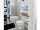 A white bathroom with a tiled bath and shower, a black and white shower curtain, and a modern toilet at 113 Plumosus Park Dr, Deland, FL 32724