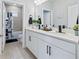 Bathroom featuring a double vanity with matte black hardware, modern sinks, and a tiled shower/bath at 113 Plumosus Park Dr, Deland, FL 32724