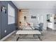 Modern dining room with a glass table, stylish seating, unique wall decor, and a view into the bathroom at 113 Plumosus Park Dr, Deland, FL 32724