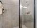 Shower stall with tile surround, glass door, and chrome shower head at 113 Plumosus Park Dr, Deland, FL 32724