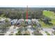 Aerial view of the home's location and community with mature trees and a golf course at 1143 Champions Dr, Daytona Beach, FL 32124