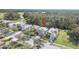 Aerial view of the home's location and community with mature trees and lush landscaping at 1143 Champions Dr, Daytona Beach, FL 32124