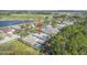 Aerial view of the home's location and community with mature trees and a community pool at 1143 Champions Dr, Daytona Beach, FL 32124