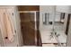 Bathroom features a glass-door shower and a vanity with double sinks and a large mirror at 1143 Champions Dr, Daytona Beach, FL 32124