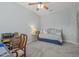 Bedroom with a bed, ceiling fan, and a small table with a lamp at 1143 Champions Dr, Daytona Beach, FL 32124