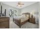 Bedroom with a queen-sized bed, ceiling fan, and a large window at 1143 Champions Dr, Daytona Beach, FL 32124