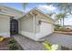 Side view of a light gray home featuring a two-car garage and beautifully maintained landscaping at 1143 Champions Dr, Daytona Beach, FL 32124