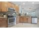 Well-equipped kitchen featuring wood cabinetry, granite countertops, and stainless steel appliances for modern cooking at 1143 Champions Dr, Daytona Beach, FL 32124