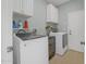 Laundry room with white cabinets, front-loading washer and dryer, and a wine cooler at 1143 Champions Dr, Daytona Beach, FL 32124