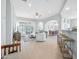 Bright open-concept living room with stylish furnishings, neutral color scheme, and seamless flow to dining area at 1143 Champions Dr, Daytona Beach, FL 32124