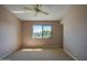 Cozy bedroom features a ceiling fan, neutral carpeting, and a window overlooking a peaceful neighborhood at 150 Limewood Pl # F, Ormond Beach, FL 32174