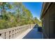 Outdoor patio overlooking lush backyard landscape with wood railing at 150 Limewood Pl # F, Ormond Beach, FL 32174