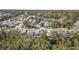 Aerial view highlights a townhome community surrounded by mature trees and convenient roadways at 25 Misners Trl, Ormond Beach, FL 32174