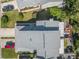 Overhead shot of a home with a gray roof, a deck with furniture, and well-maintained landscaping at 25 Misners Trl, Ormond Beach, FL 32174