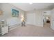 Neutral bedroom featuring white wicker furniture, art, and natural light at 25 Misners Trl, Ormond Beach, FL 32174