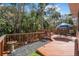 Wooden deck with outdoor furniture surrounded by lush greenery at 25 Misners Trl, Ormond Beach, FL 32174