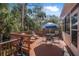 Outdoor deck with seating, umbrella, and tropical greenery at 25 Misners Trl, Ormond Beach, FL 32174