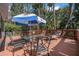 Inviting deck with patio furniture, umbrella, and seating, surrounded by greenery at 25 Misners Trl, Ormond Beach, FL 32174