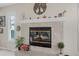 A close-up of the fireplace with a white mantel and stone surround at 25 Misners Trl, Ormond Beach, FL 32174