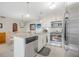 Well-lit kitchen featuring granite counters, white cabinetry, and stainless steel appliances at 25 Misners Trl, Ormond Beach, FL 32174