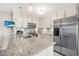 Kitchen with granite countertops, white cabinets, and stainless steel appliances at 25 Misners Trl, Ormond Beach, FL 32174