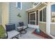 Inviting front porch with seating area, decorative plants, and a view of the home's entrance at 25 Misners Trl, Ormond Beach, FL 32174