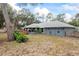 A well-kept gray home is situated on a lot featuring a fenced yard and a hot tub at 290 Birch Ave, Orange City, FL 32763