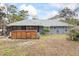 Exterior backyard view with a hot tub, a patio, and lush green surroundings at 290 Birch Ave, Orange City, FL 32763