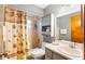 Cozy bathroom with a shower and tub combination and storage cabinet above the toilet at 290 Birch Ave, Orange City, FL 32763