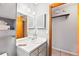 Neutral bathroom with a white vanity, mirror, toilet, and a doorway leading to a closet space for storage at 290 Birch Ave, Orange City, FL 32763