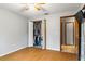 Bedroom with hardwood floors and closet with double doors at 290 Birch Ave, Orange City, FL 32763