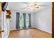 Empty bedroom with hardwood floors and curtains over the bright window at 290 Birch Ave, Orange City, FL 32763