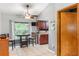 Dinette area with a ceiling fan, tile floor and adjacent dark wood cabinets with solid surface countertops at 290 Birch Ave, Orange City, FL 32763