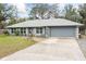 Well-maintained, one-story home with a gray exterior, gray roof, and two-car garage at 290 Birch Ave, Orange City, FL 32763