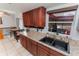 Cherry cabinets and granite countertops accent the double sink in this charming kitchen at 290 Birch Ave, Orange City, FL 32763