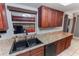 This functional kitchen features cherry cabinets, granite countertops, and a black sink and dishwasher at 290 Birch Ave, Orange City, FL 32763