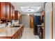 A galley-style kitchen with plenty of storage cabinets and solid surface countertops with tile floors at 290 Birch Ave, Orange City, FL 32763