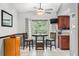 Cozy kitchen nook with a small round table and view of the outdoors, illuminated by modern ceiling fan and light fixture at 290 Birch Ave, Orange City, FL 32763