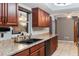 Kitchen featuring wood cabinets, solid surface countertops, modern appliances and tile floors at 290 Birch Ave, Orange City, FL 32763