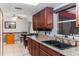 Cherry cabinets and granite countertops complement the double sink in this bright kitchen at 290 Birch Ave, Orange City, FL 32763