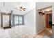 Spacious living room featuring tile floors, a ceiling fan, and plenty of natural light at 290 Birch Ave, Orange City, FL 32763