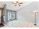 Bright living room with vaulted ceilings, tile floors and natural light pouring in from the large windows at 290 Birch Ave, Orange City, FL 32763